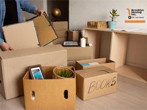 Packed cardboard boxes in a room.